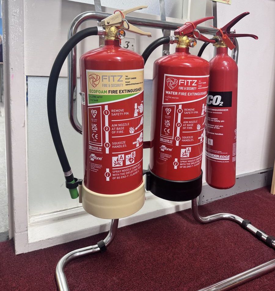 FITZ FIRE & SECURITY foam, water and CO2 fire extinguishers on a stand