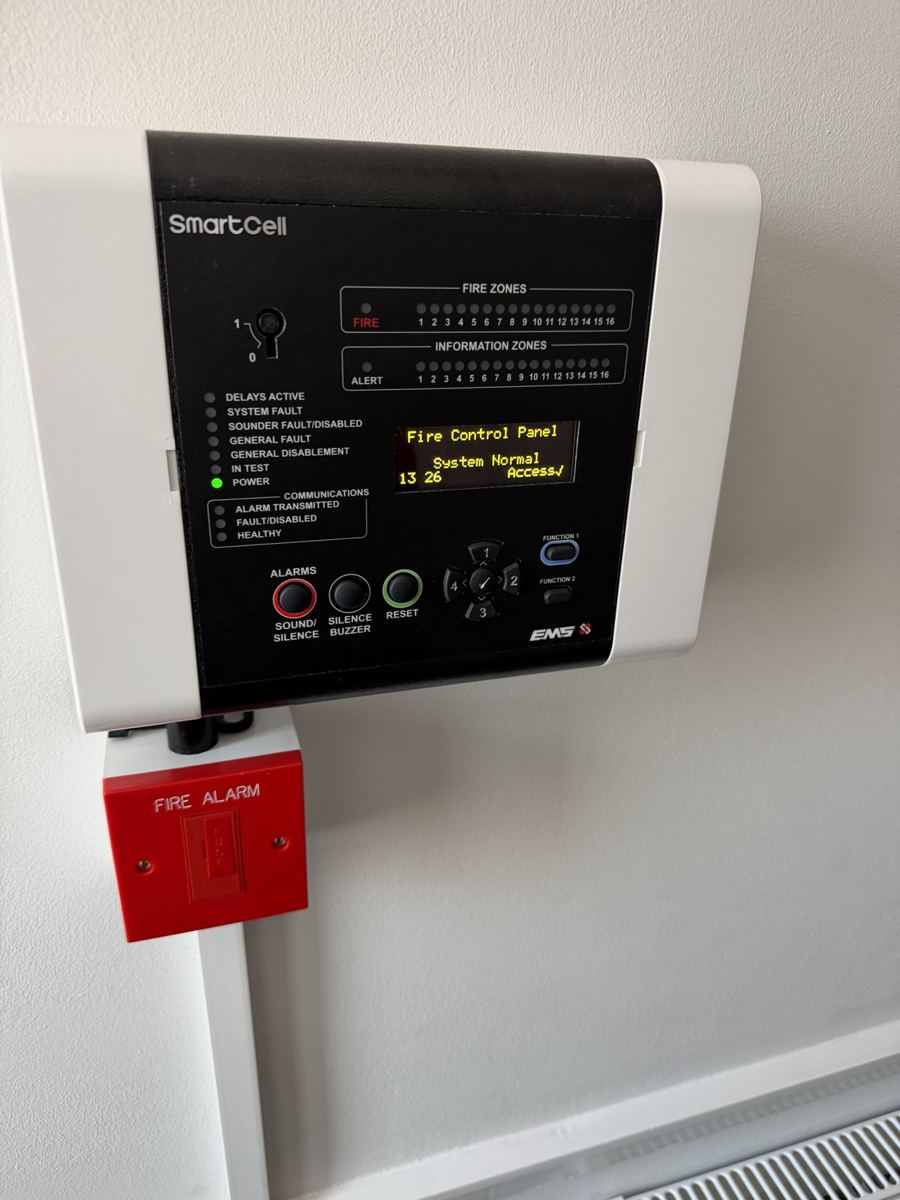 Wireless fire alarm control panel with a manual call point below